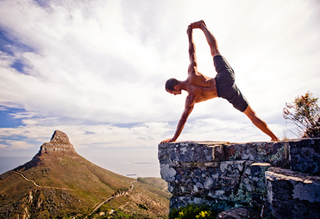 man doing risky pose asana on a cliff nature best yoga photographers